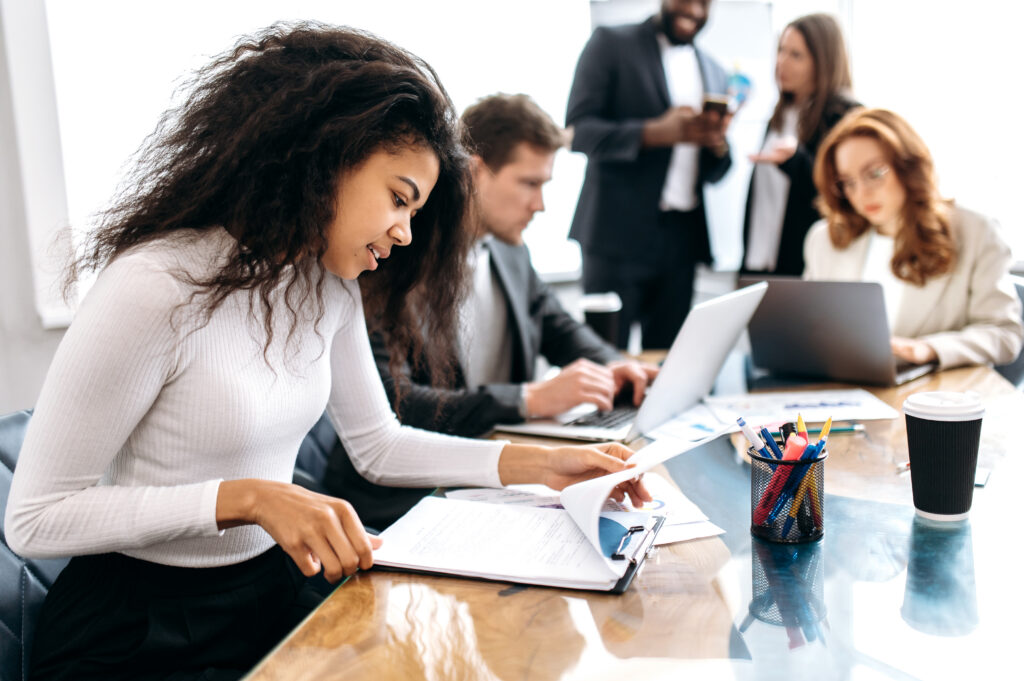 Employees working together inside a sales and marketing agency.