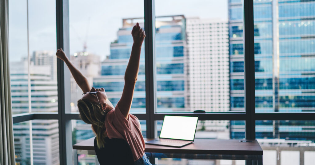 A happy employee working alone in her first job.